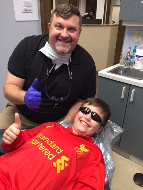 Dr. Baccellieri Jr. with a happy teenager after his treament at Baccellieri Family Dentistry.